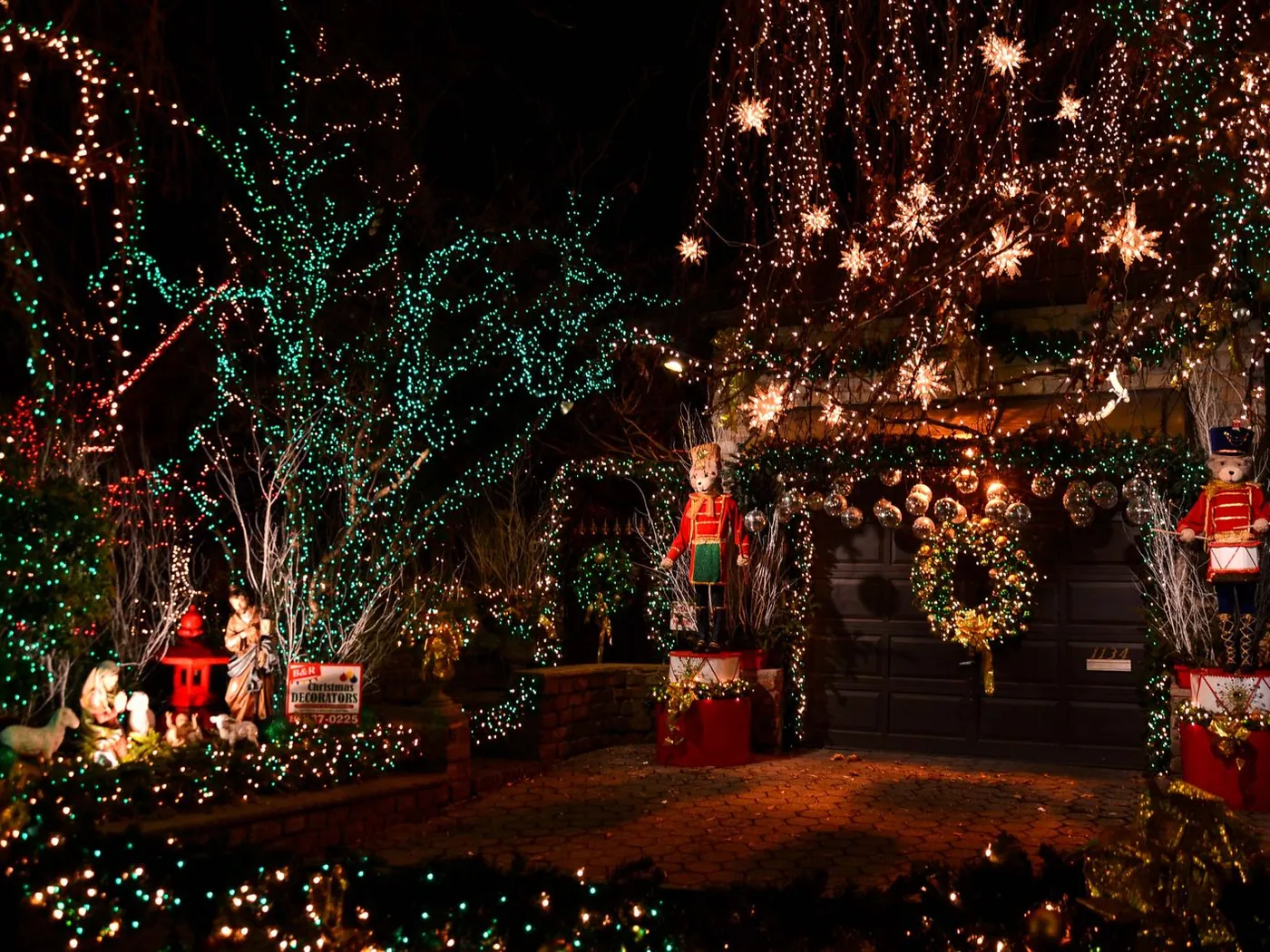 A house covered in Christmas lights and nutcracker figures