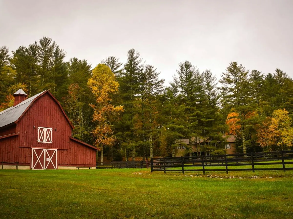 A red barn and autumn treeline on a Hudson Valley estate
